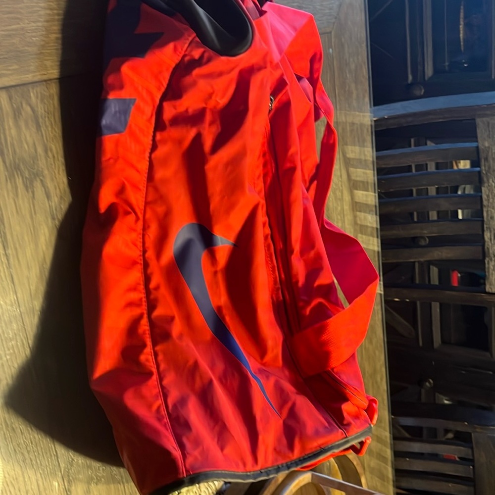 Nike new/ never used Red, black with blue lettering duffle bag